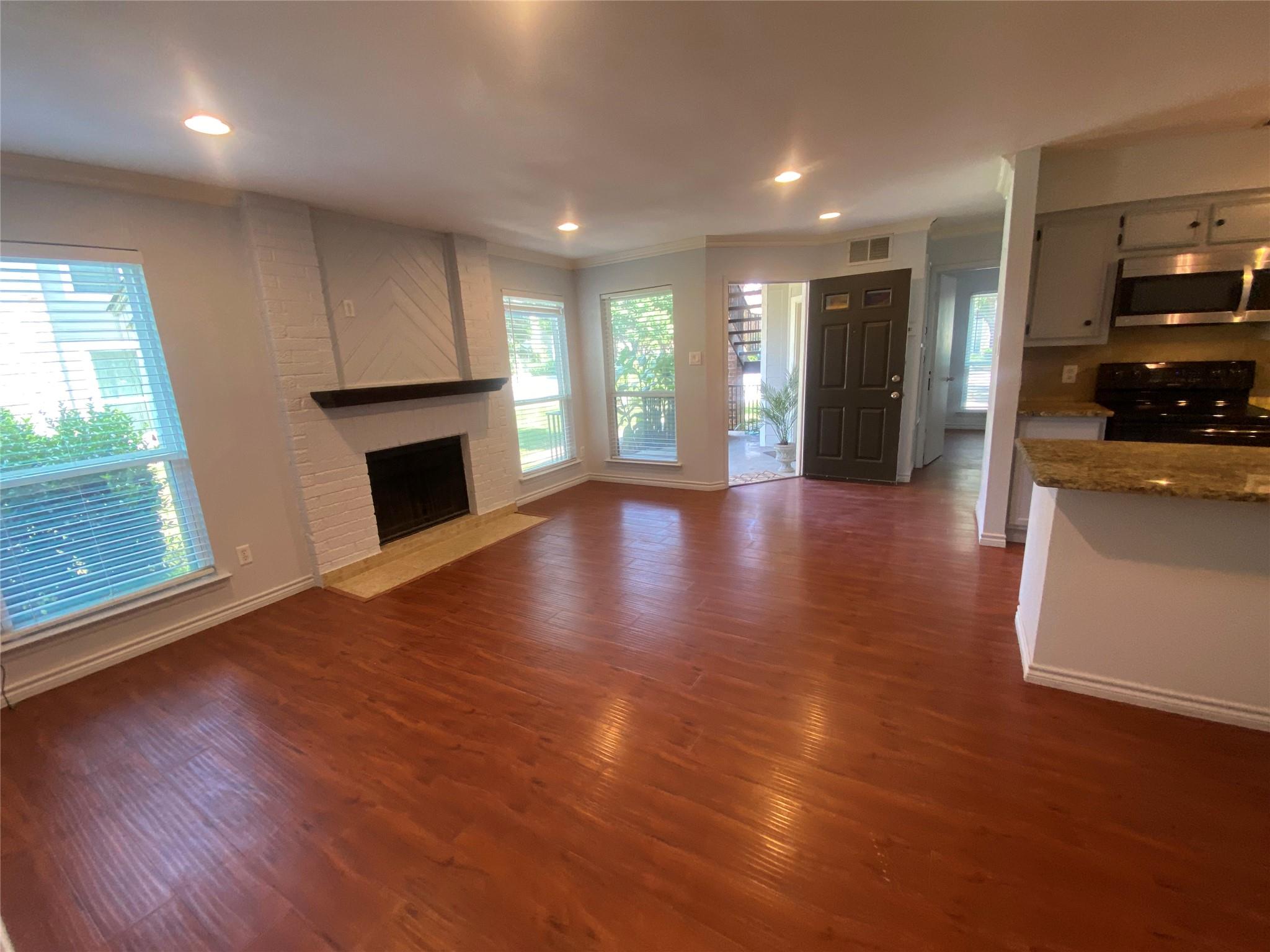Warm wood-toned flooring extends through an invit