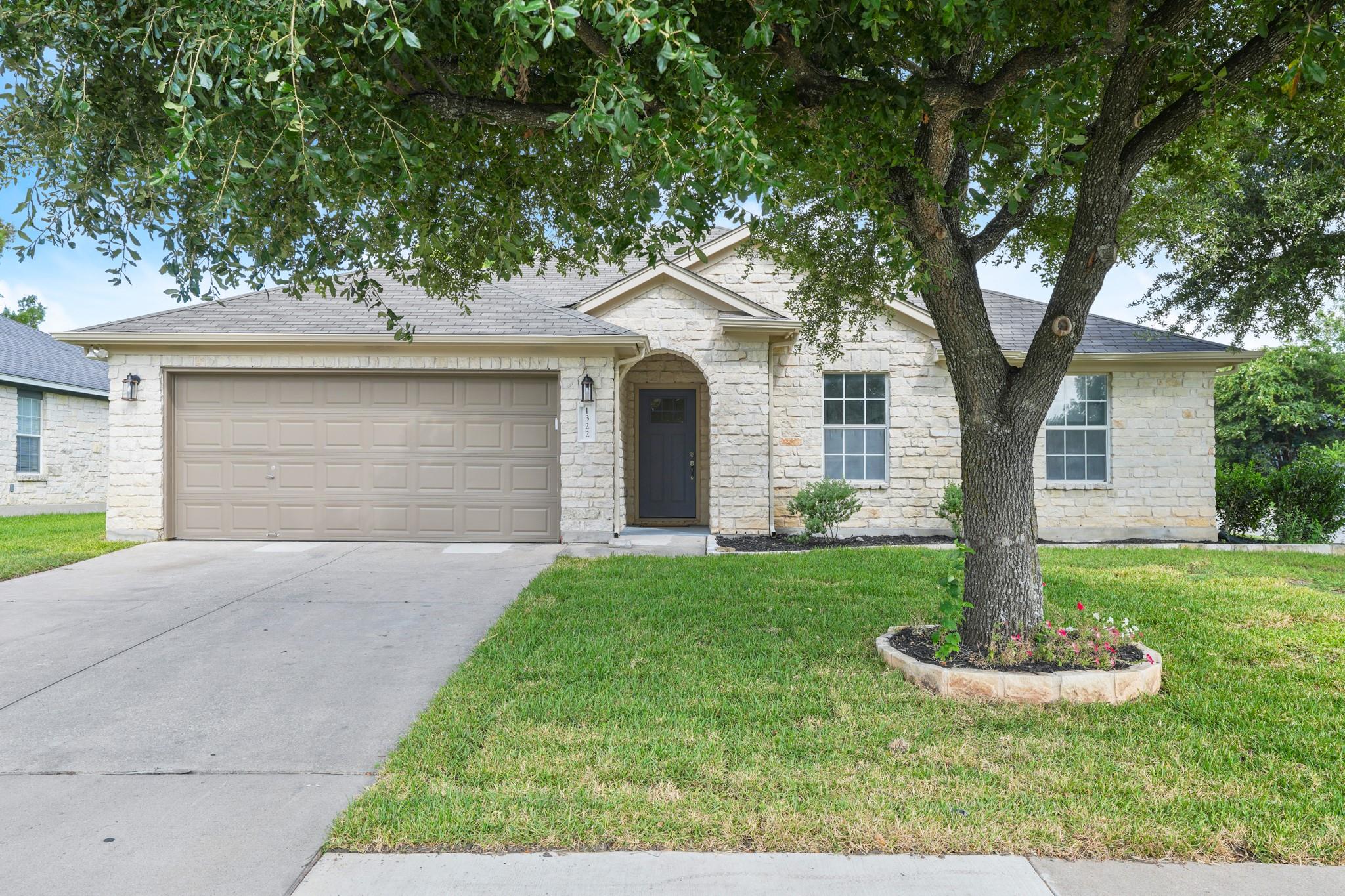 A classic brick exterior and a neat lawn create i