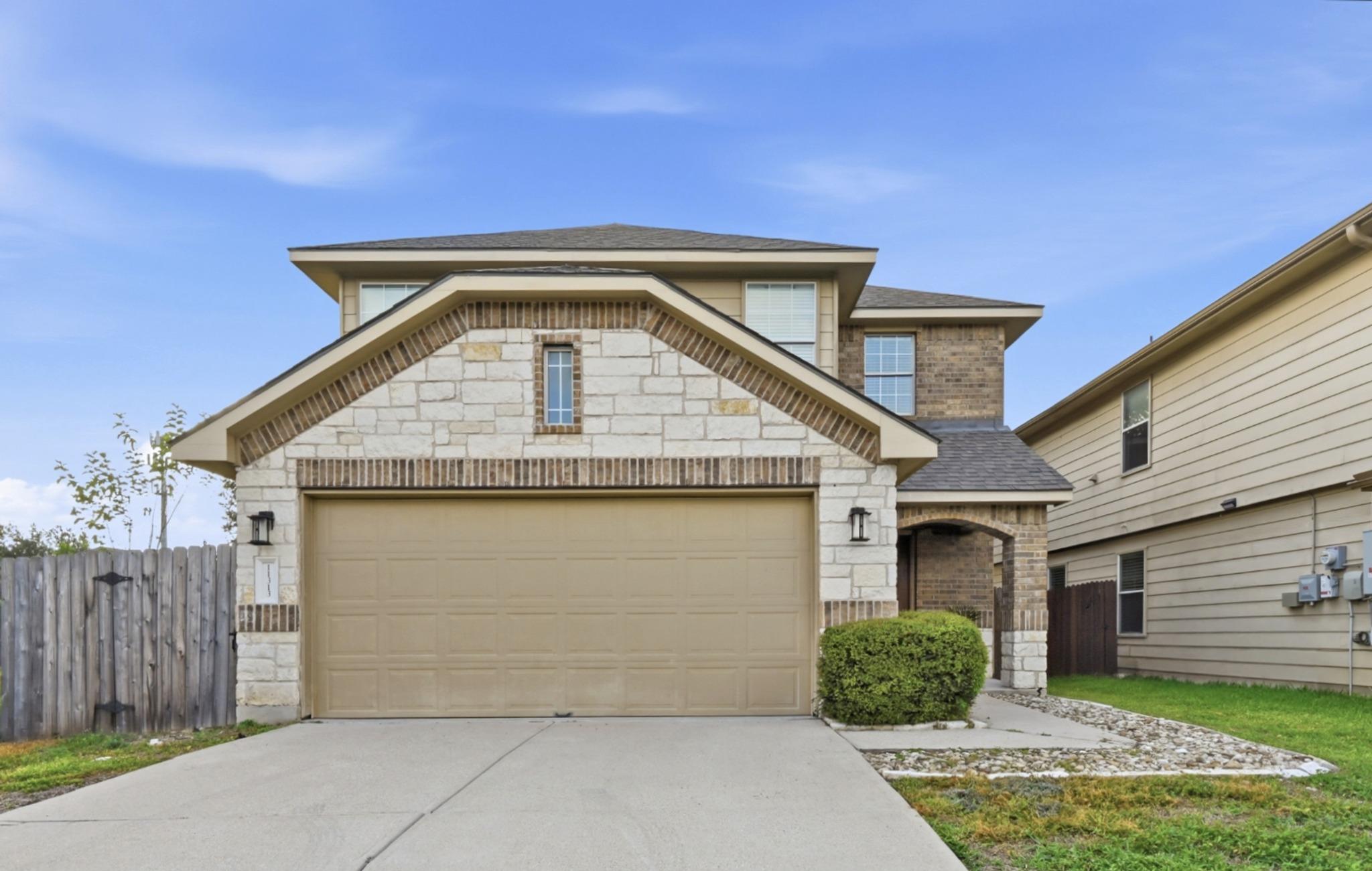 A welcoming facade showcases a two-story home wit