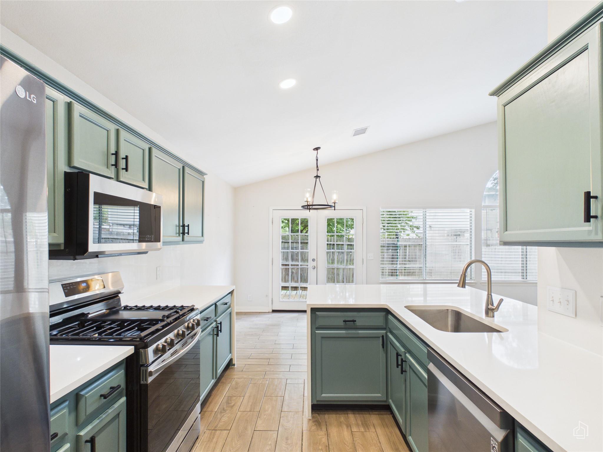 Vast vaulted ceilings complement this kitchen, bo