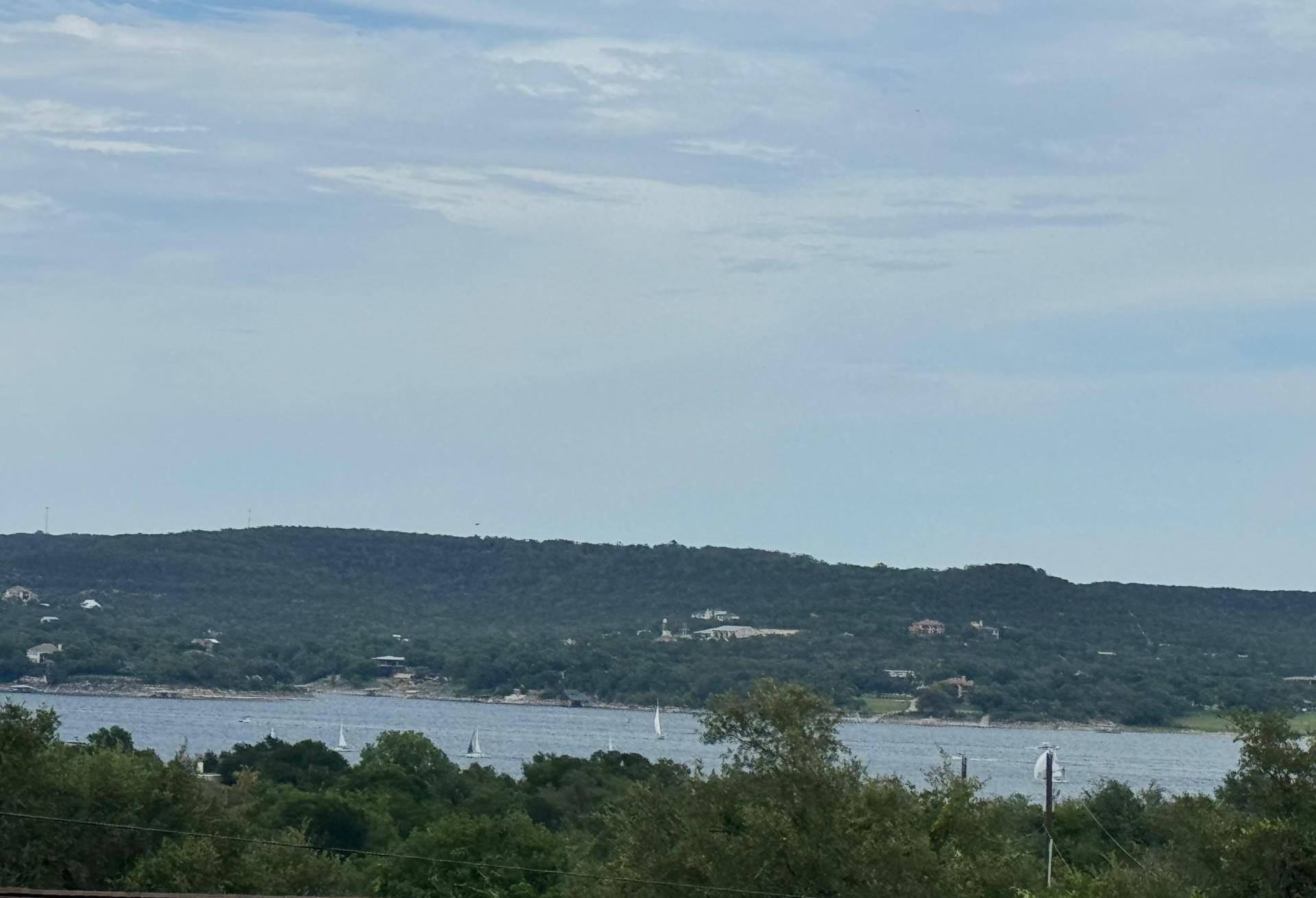 Distant homes dot the tree-lined hills surroundin