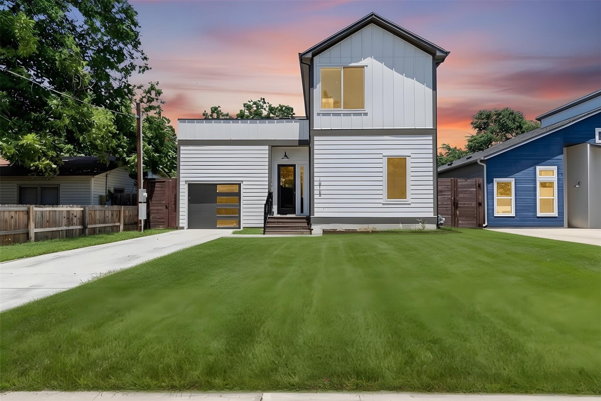 Modern facade with a sleek garage door and inviti