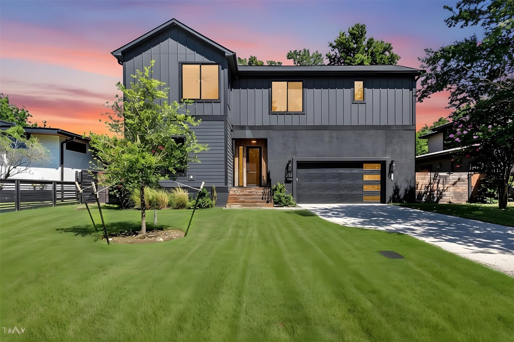 A modern facade with striking dark siding and a w