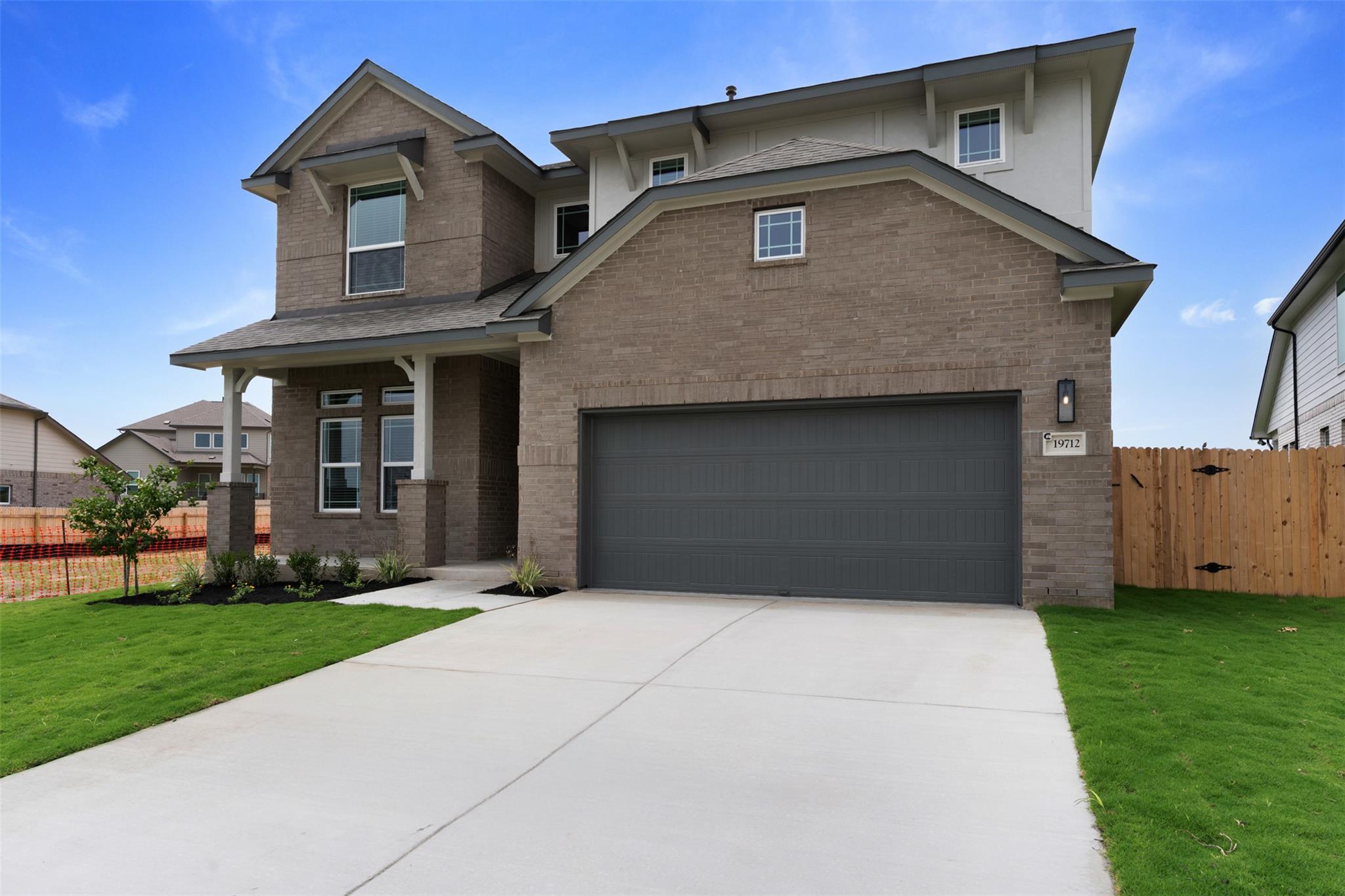 Contemporary two-story residence featuring a bric