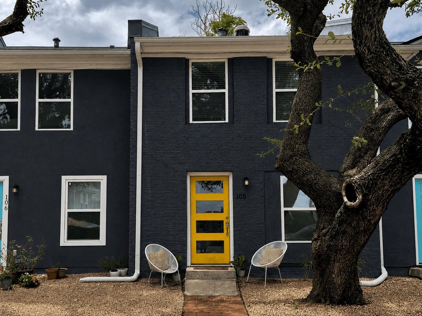 A vivid yellow door creates a striking focal poin