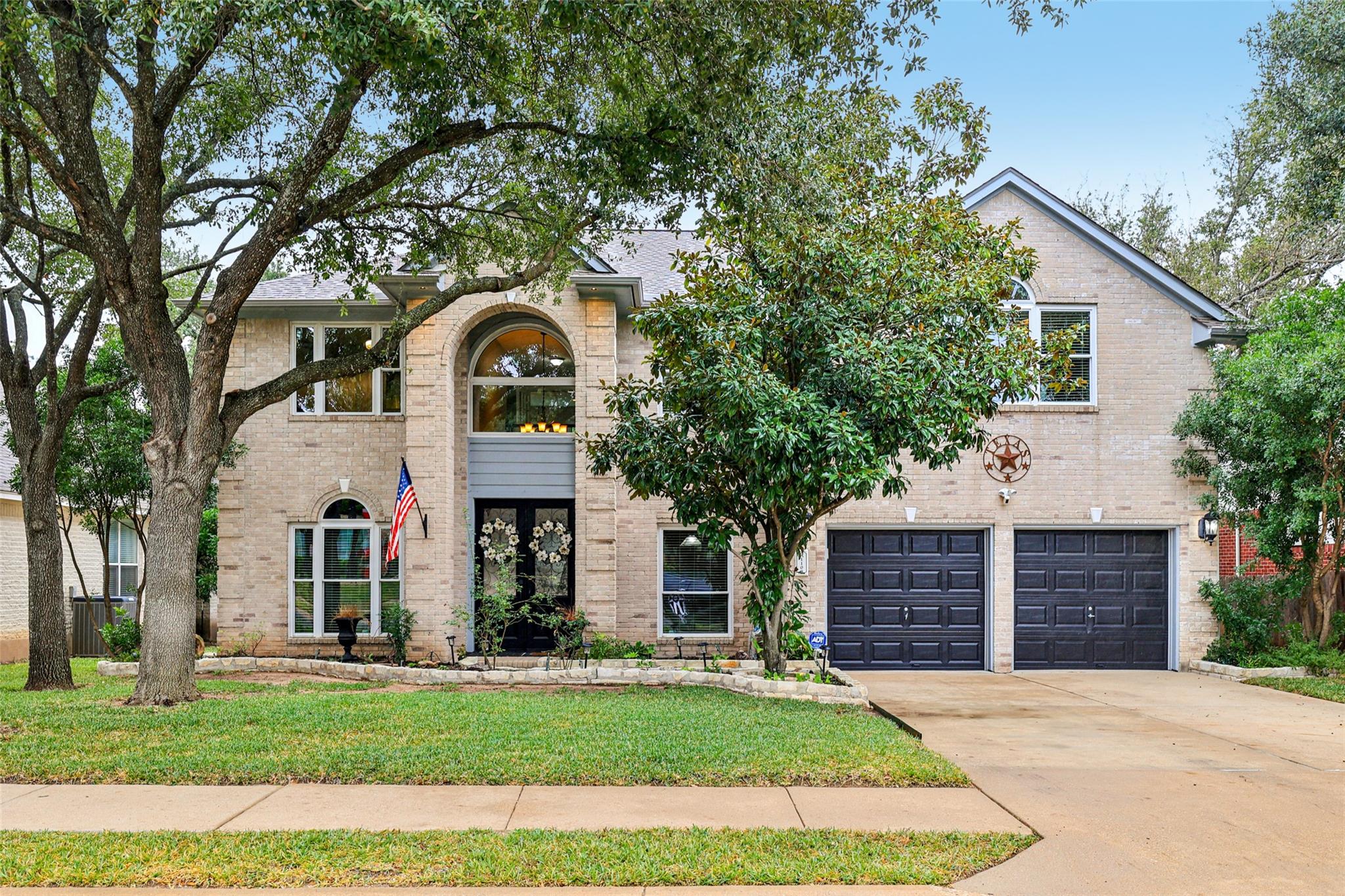 A well-maintained brick exterior with lush landsc