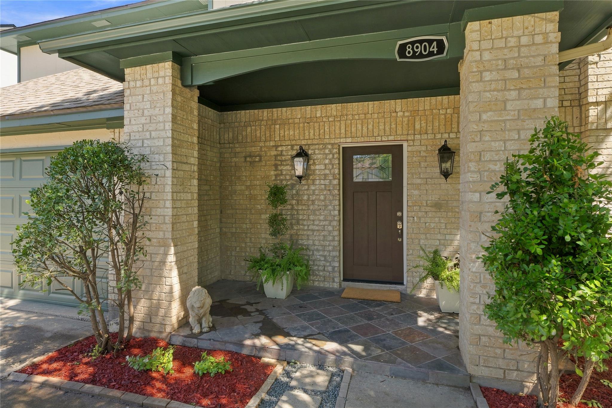A welcoming brick entryway features classic outdo
