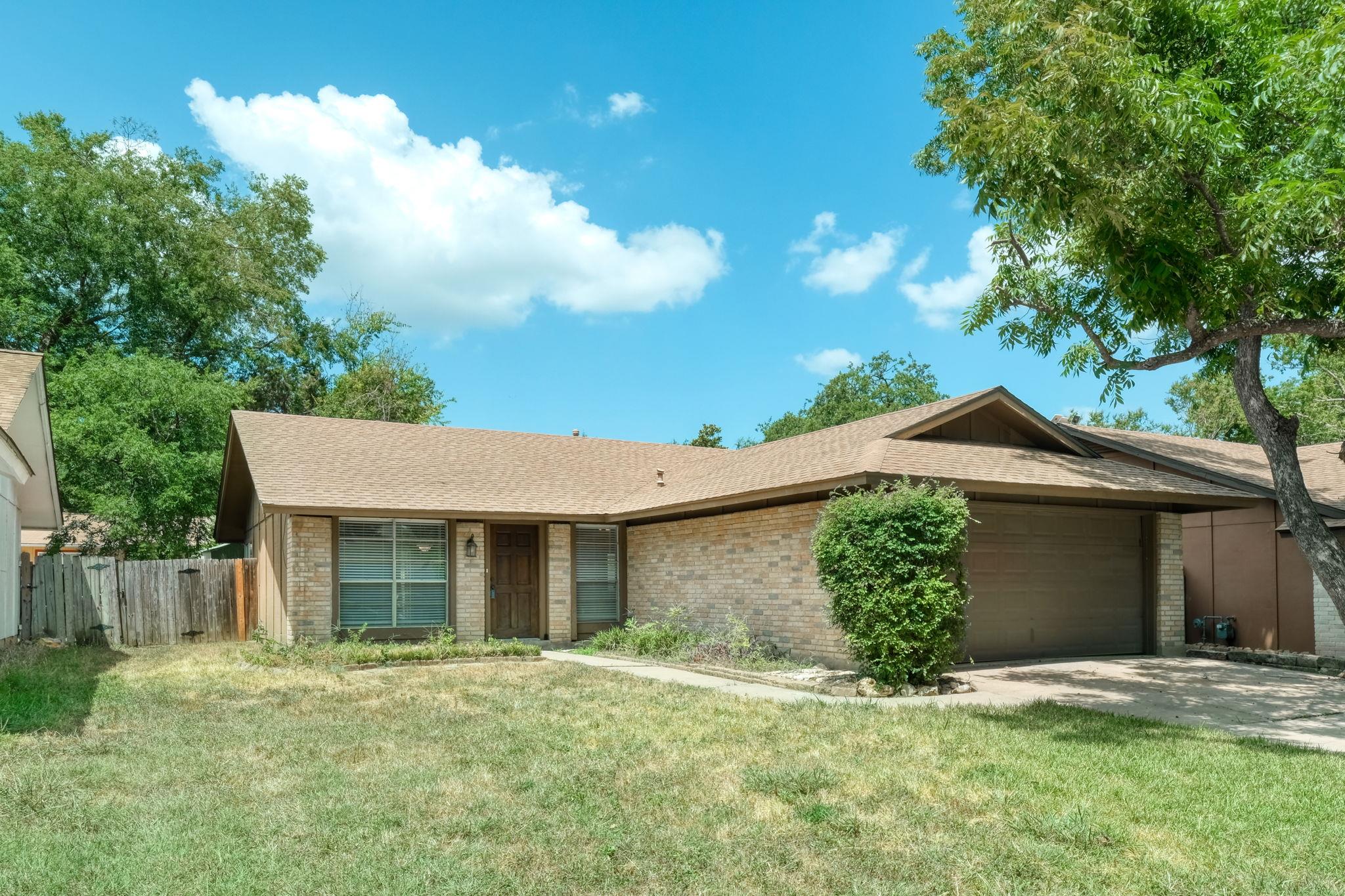 A classic brick-front home with an attached garag