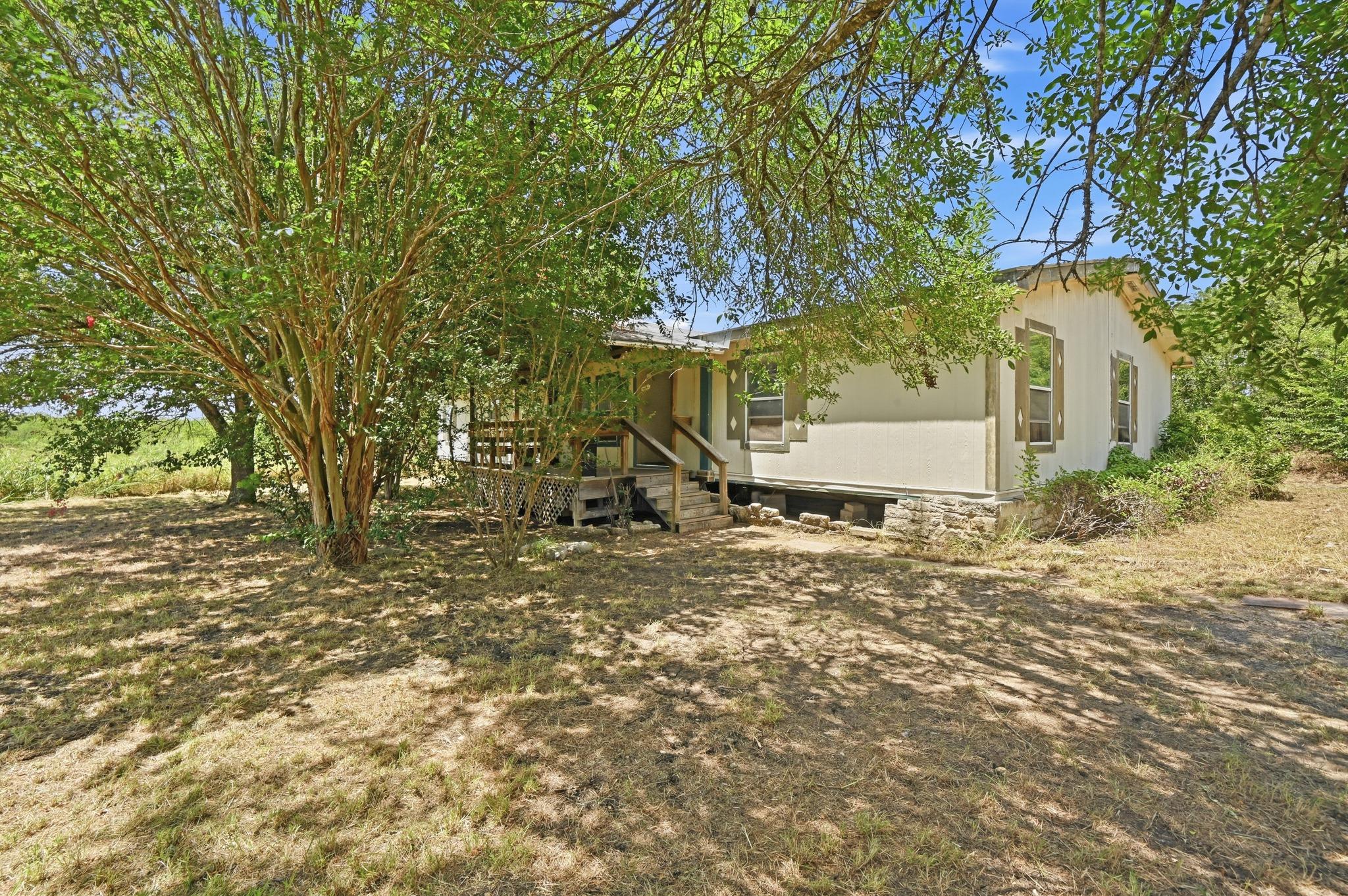 A quaint residence nestled amidst mature trees of