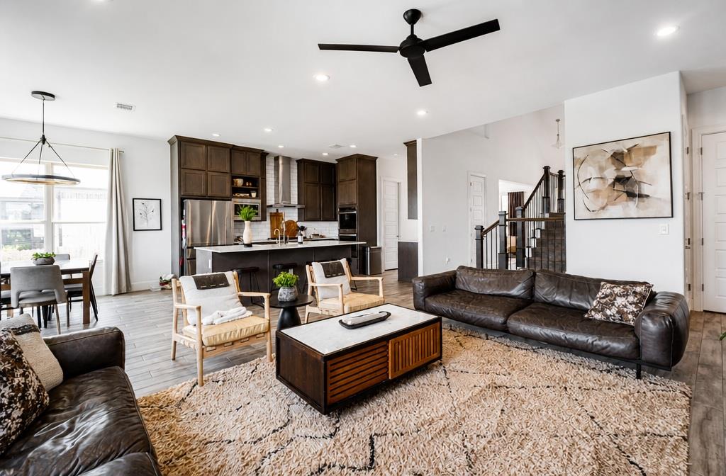 An open concept living area features soaring ceil