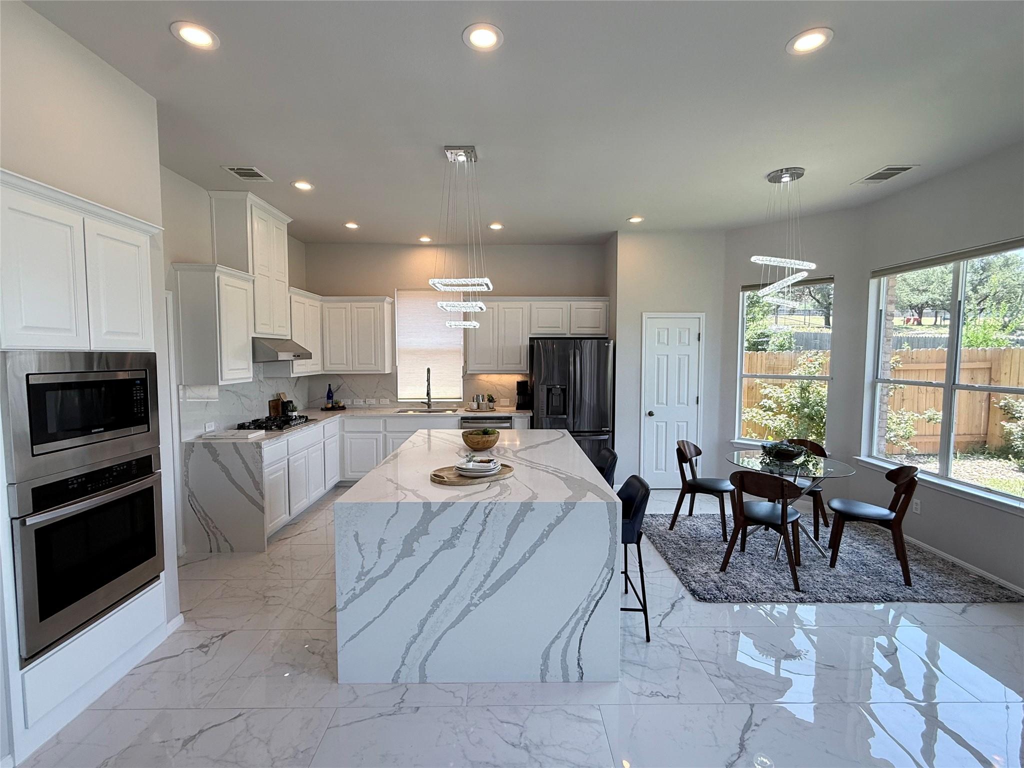 A well-lit kitchen with sleek countertops and amp
