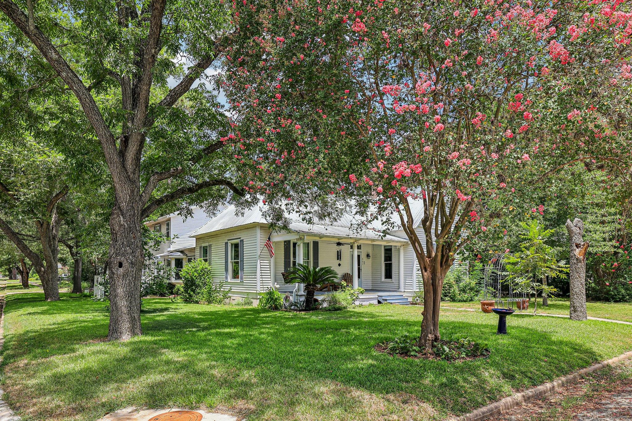A charming residence nestled in lush greenery, fe