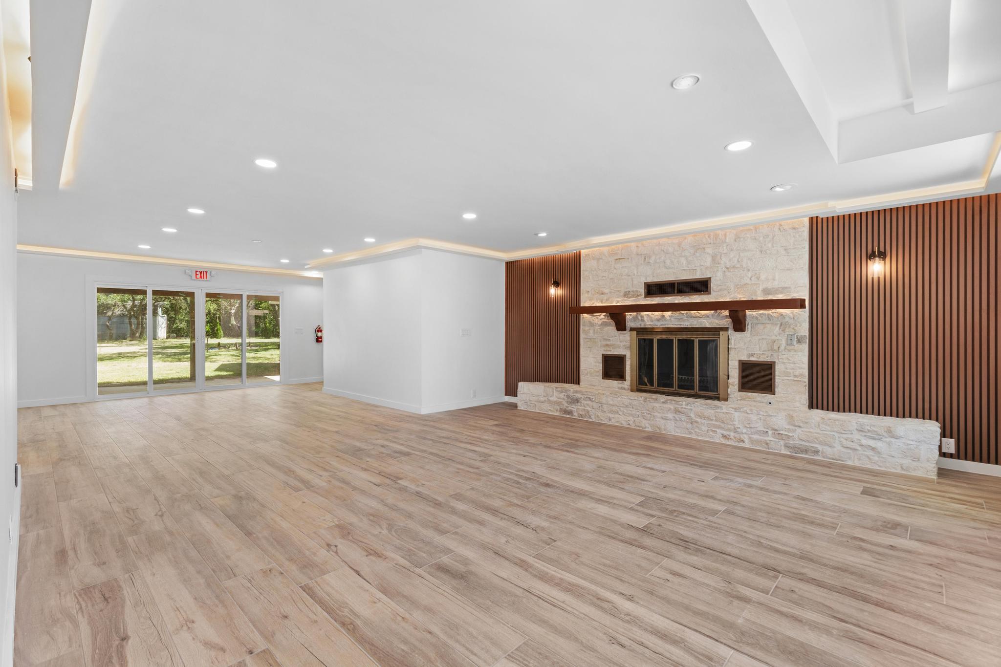 A spacious room features a beautiful stone firepl