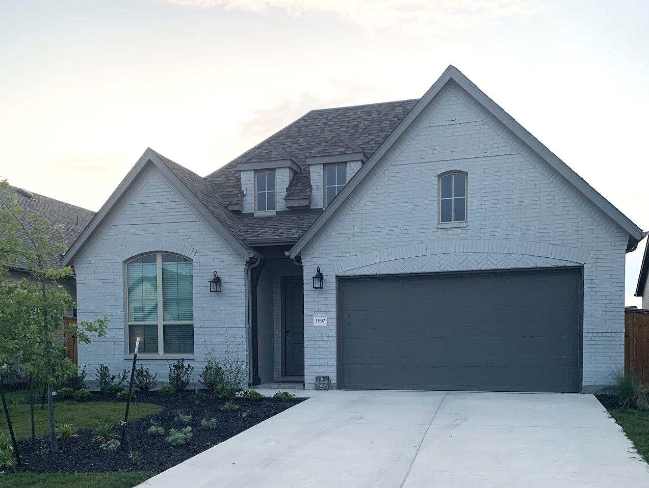 A striking gray brick facade with dormer windows 