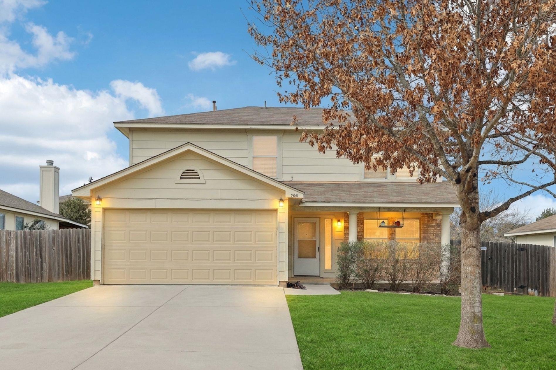 A welcoming facade features a two-story design wi
