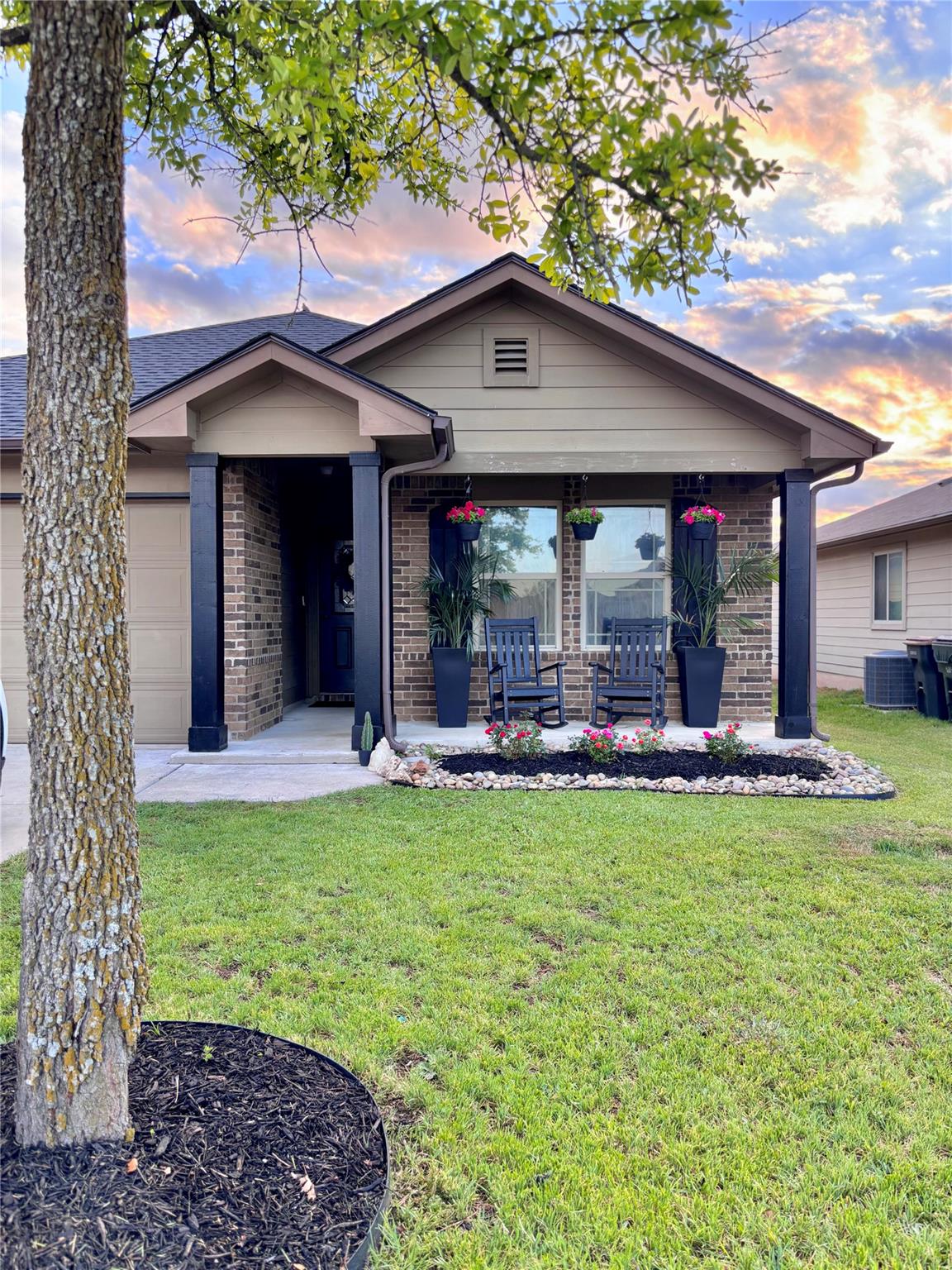 A welcoming front porch with charming black rocki