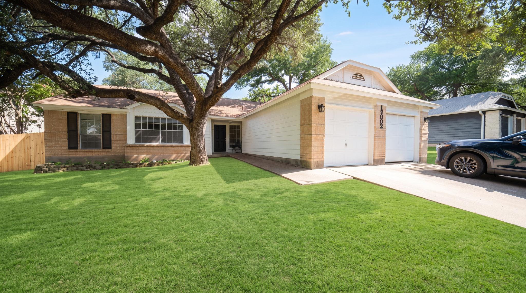 A well-maintained lawn and mature tree enhance th
