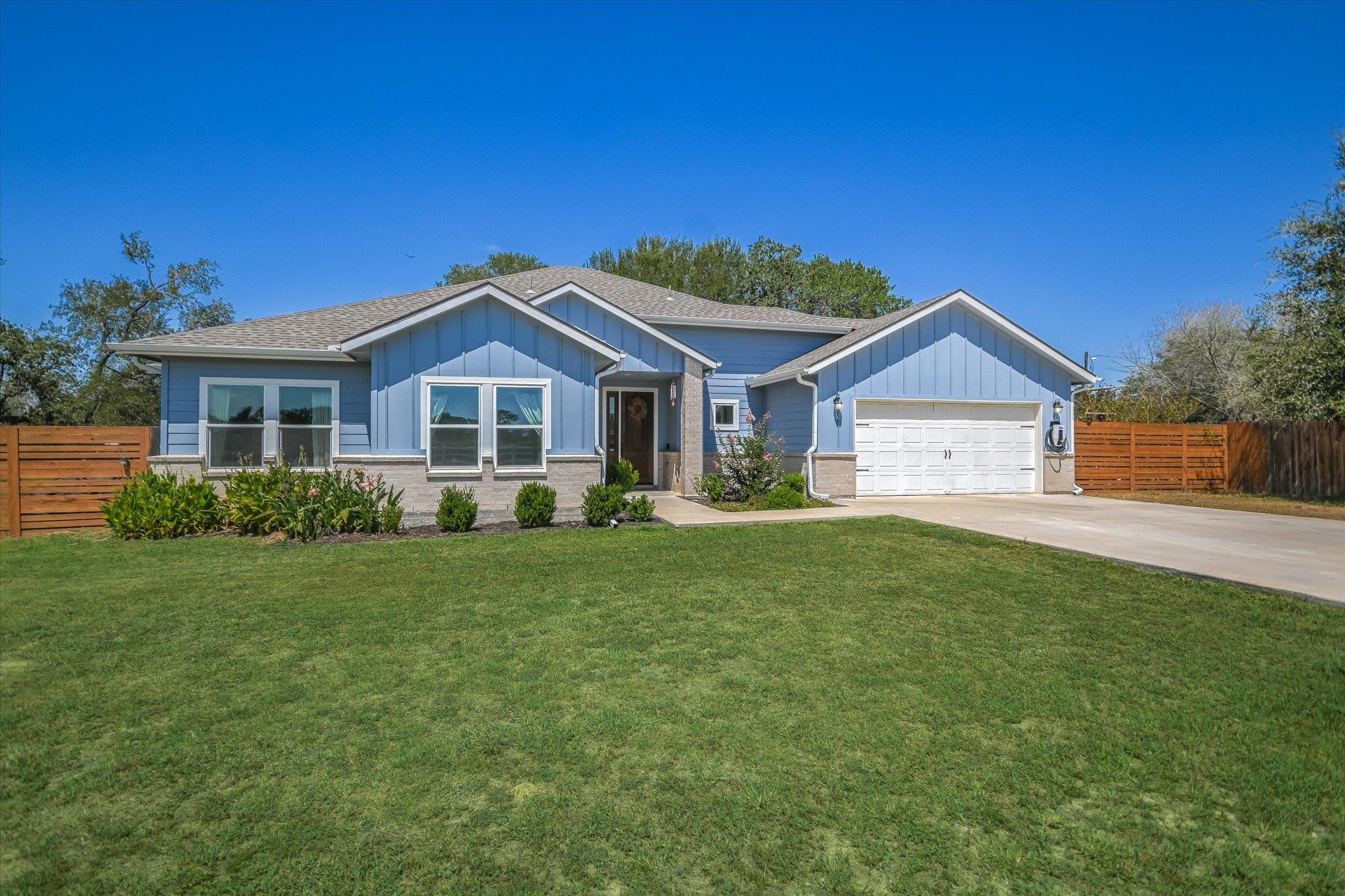 A neatly maintained lawn fronts this inviting lig