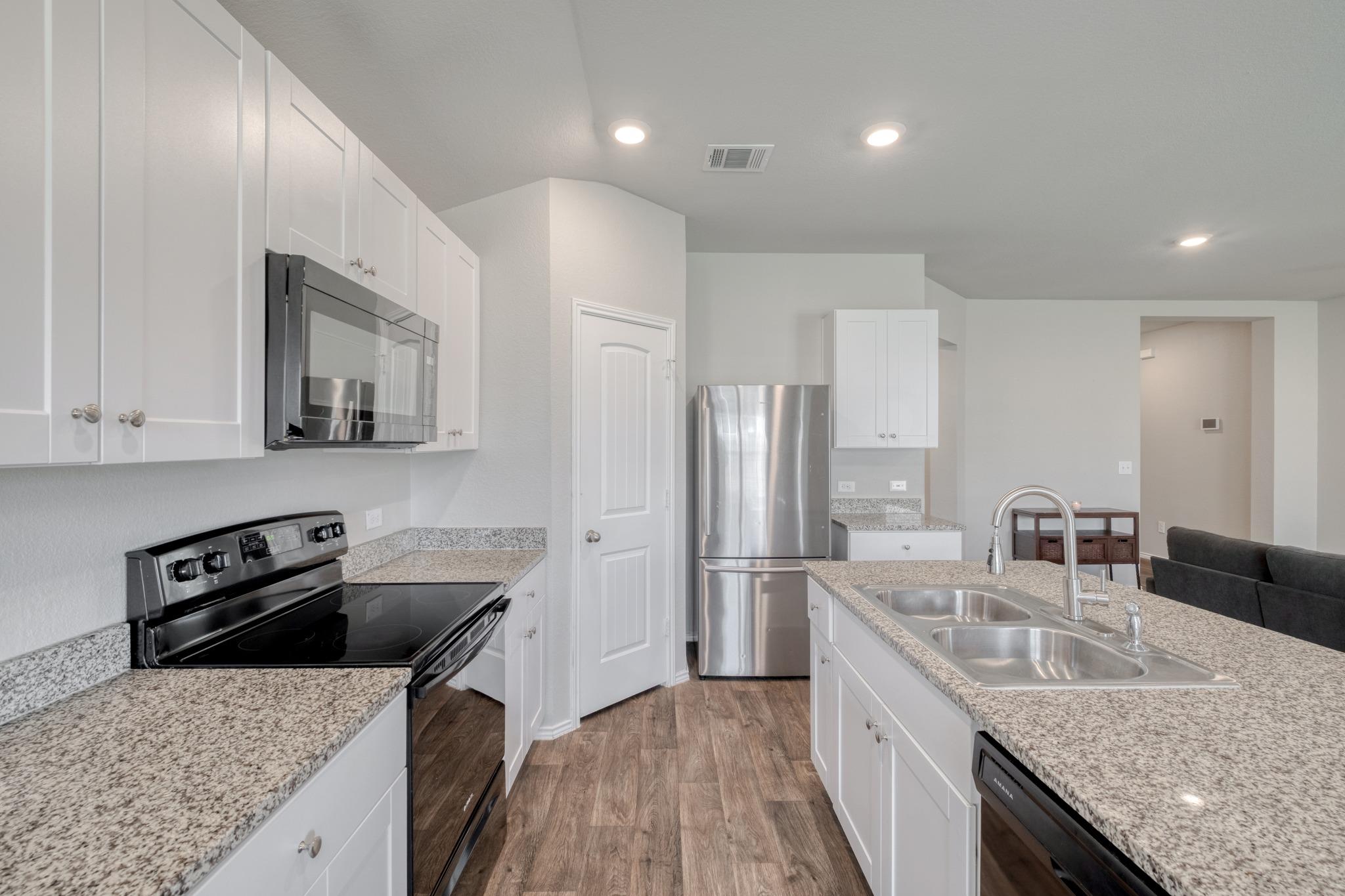 Granite countertops and stainless steel appliance