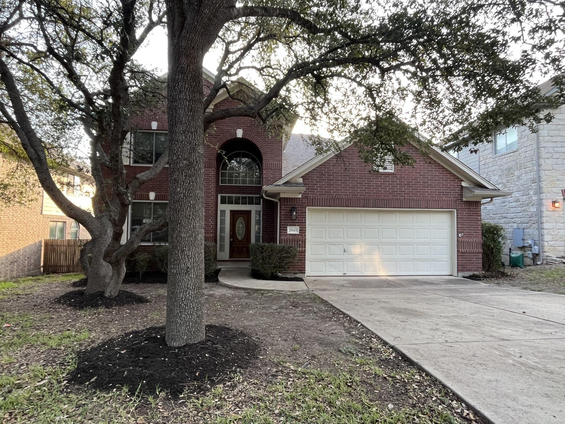A classic brick facade welcomes with a stately ar