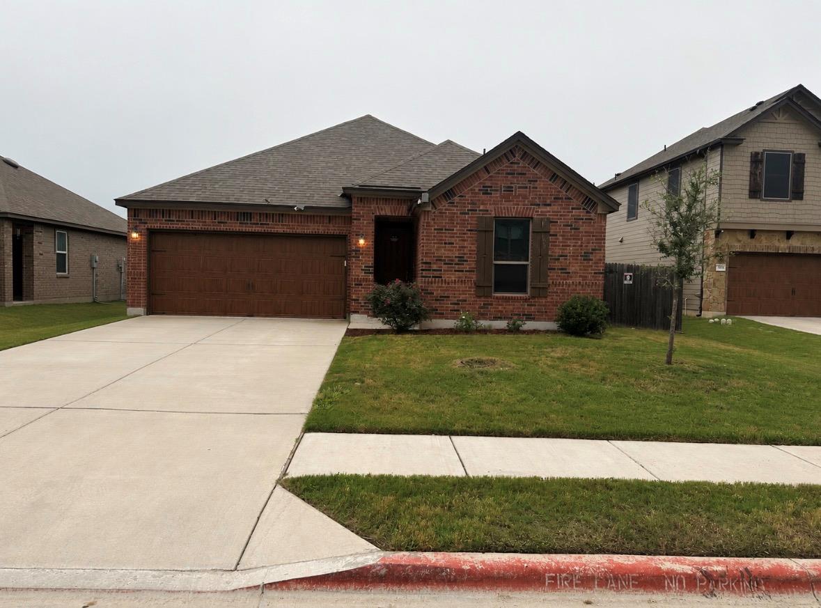 A classic brick exterior with a two-car garage we