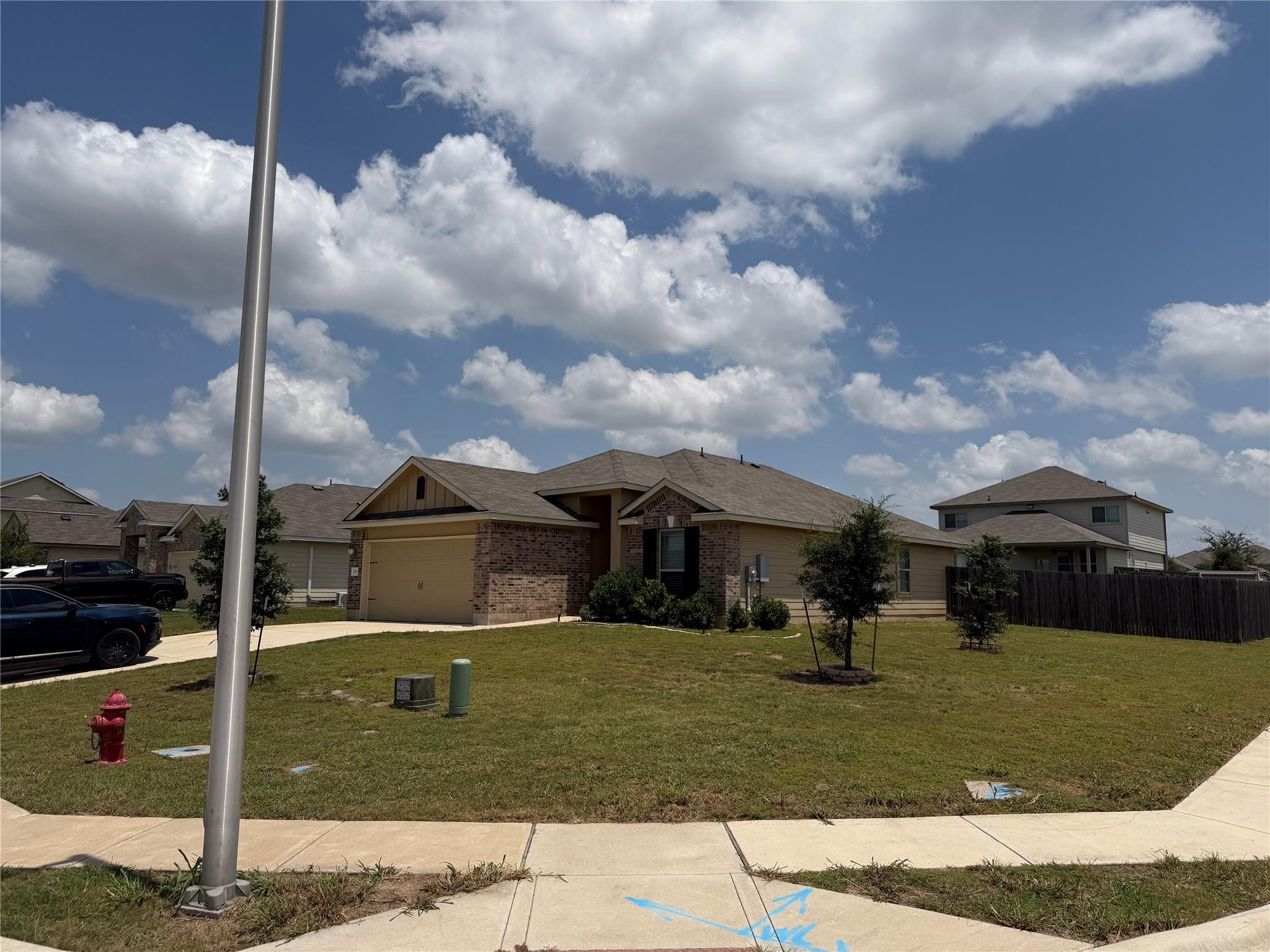 A well-maintained lawn and sturdy wooden fence fr
