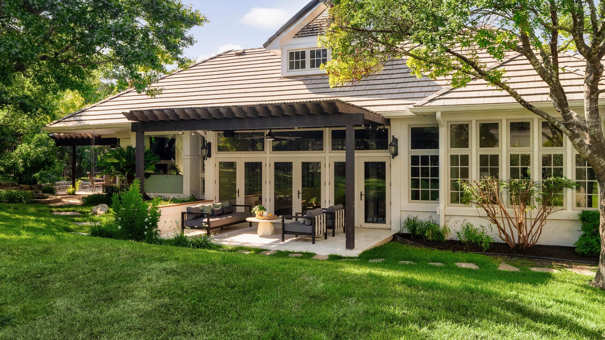 Back of property featuring a patio, an outdoor li