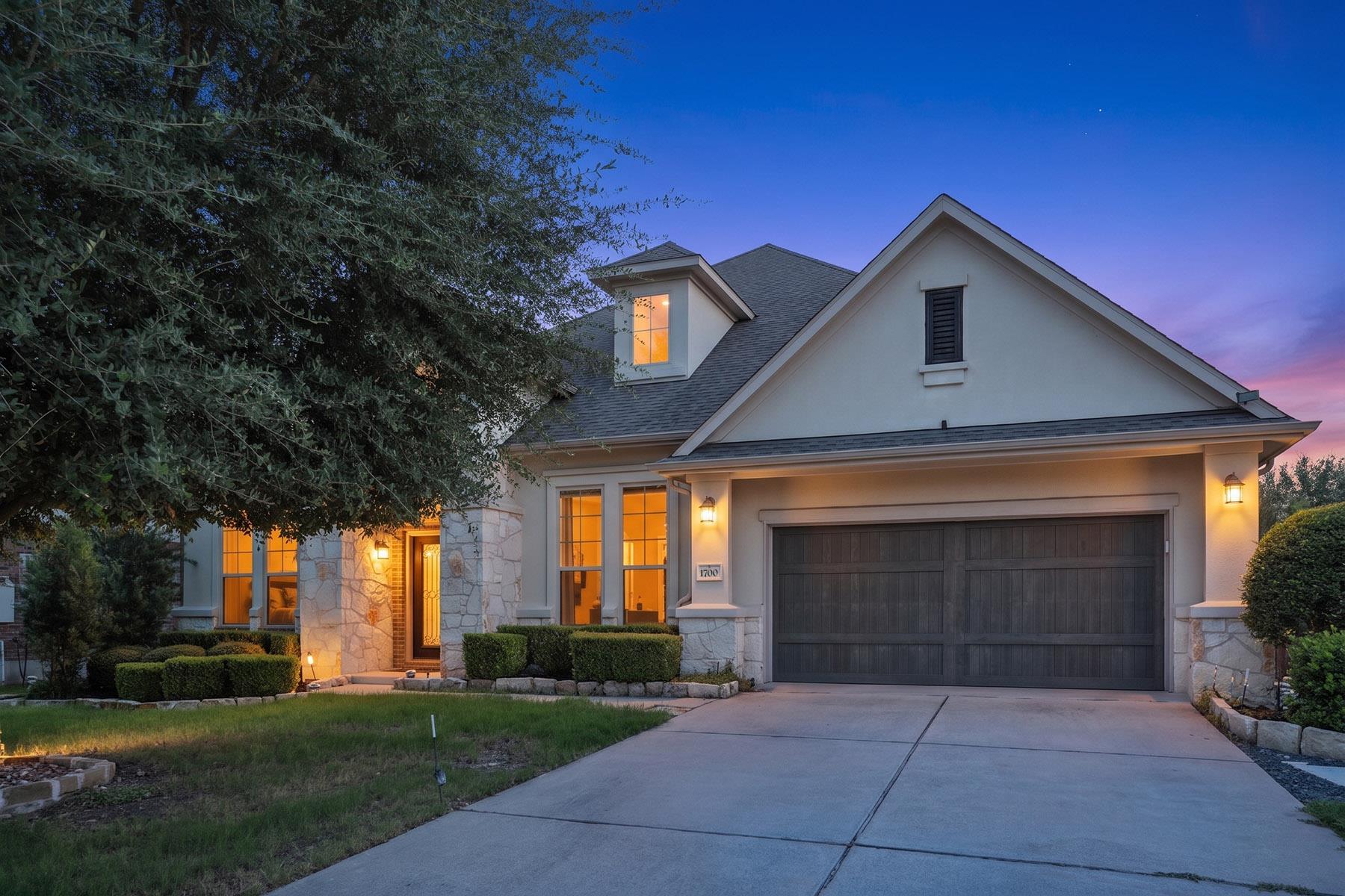 Elegant stone accents and manicured landscaping f