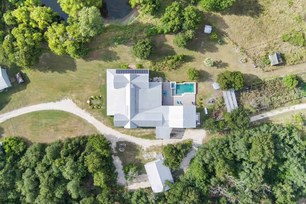 An aerial perspective reveals a private pool alon