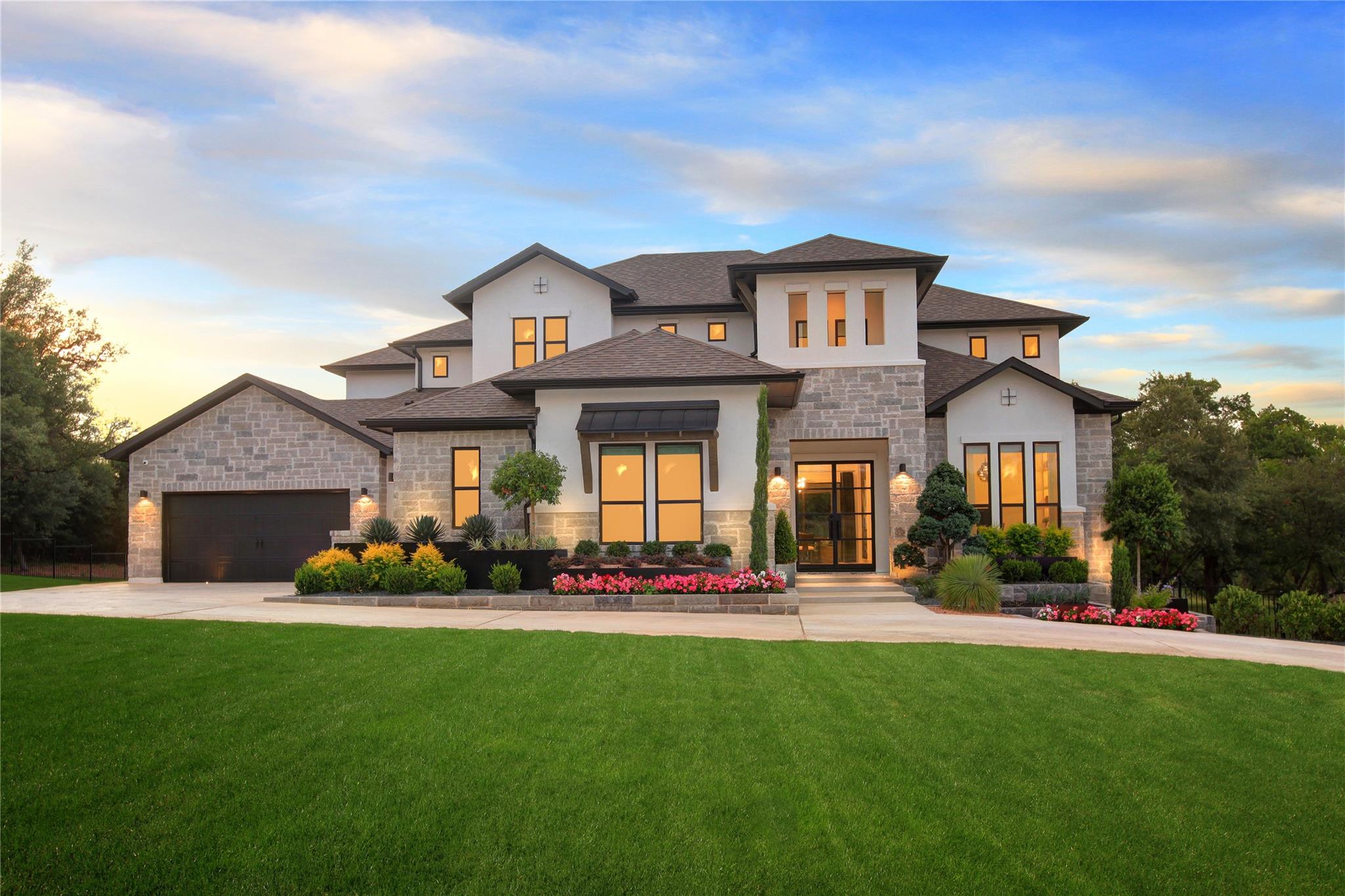 Manicured lawns frame the striking stone and stuc