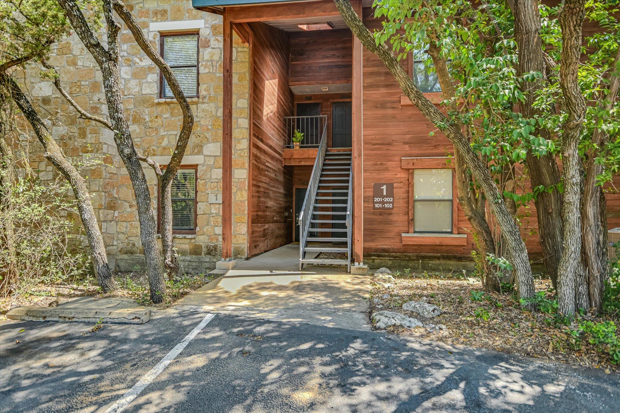Natural stone and wood siding details accent the 