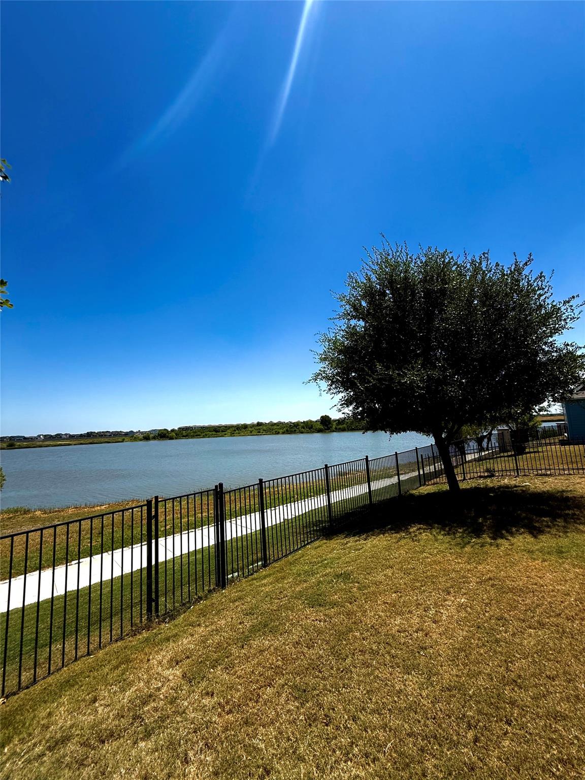 A picturesque lake view with a walking path, bord