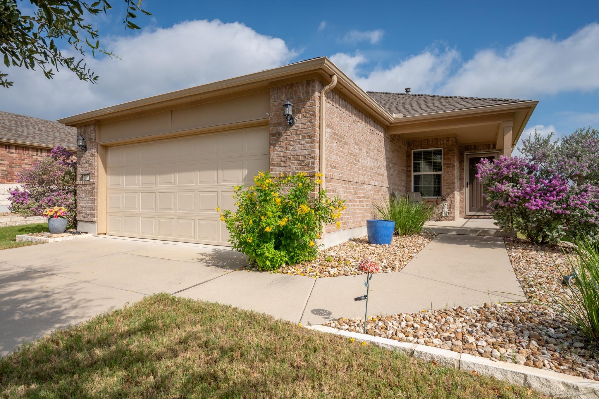 A welcoming brick exterior features an attached g