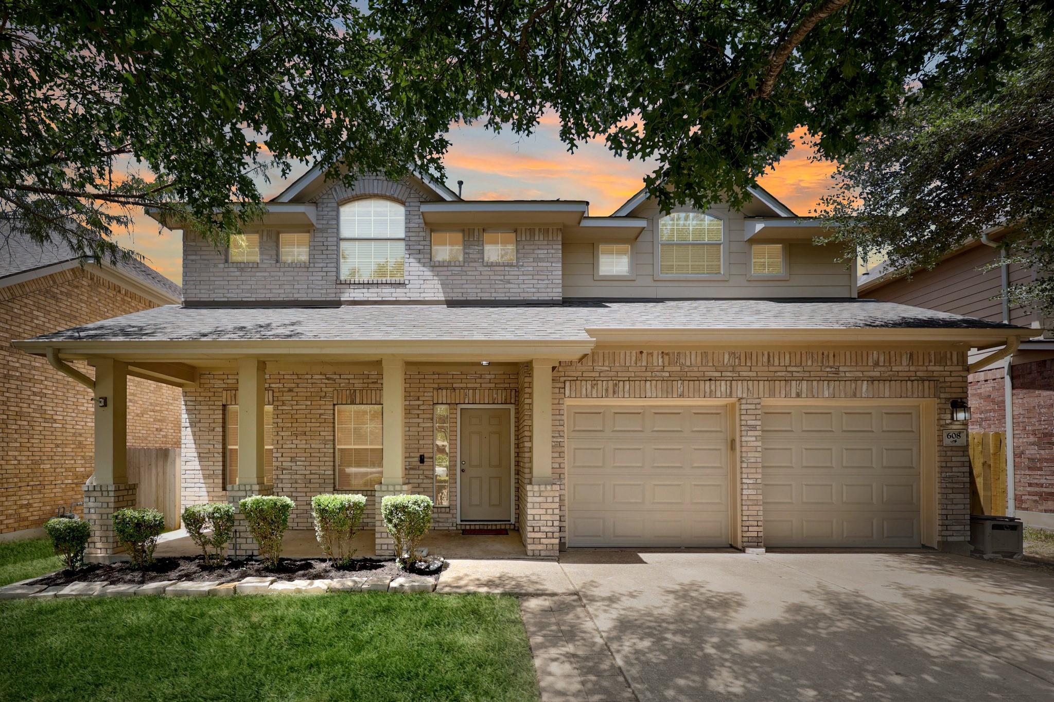 A charming two-story home with a classic brick fa