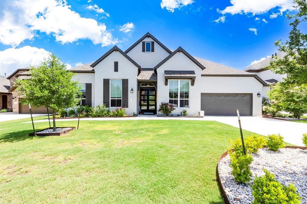 White brick exterior with dark trim and shutters 