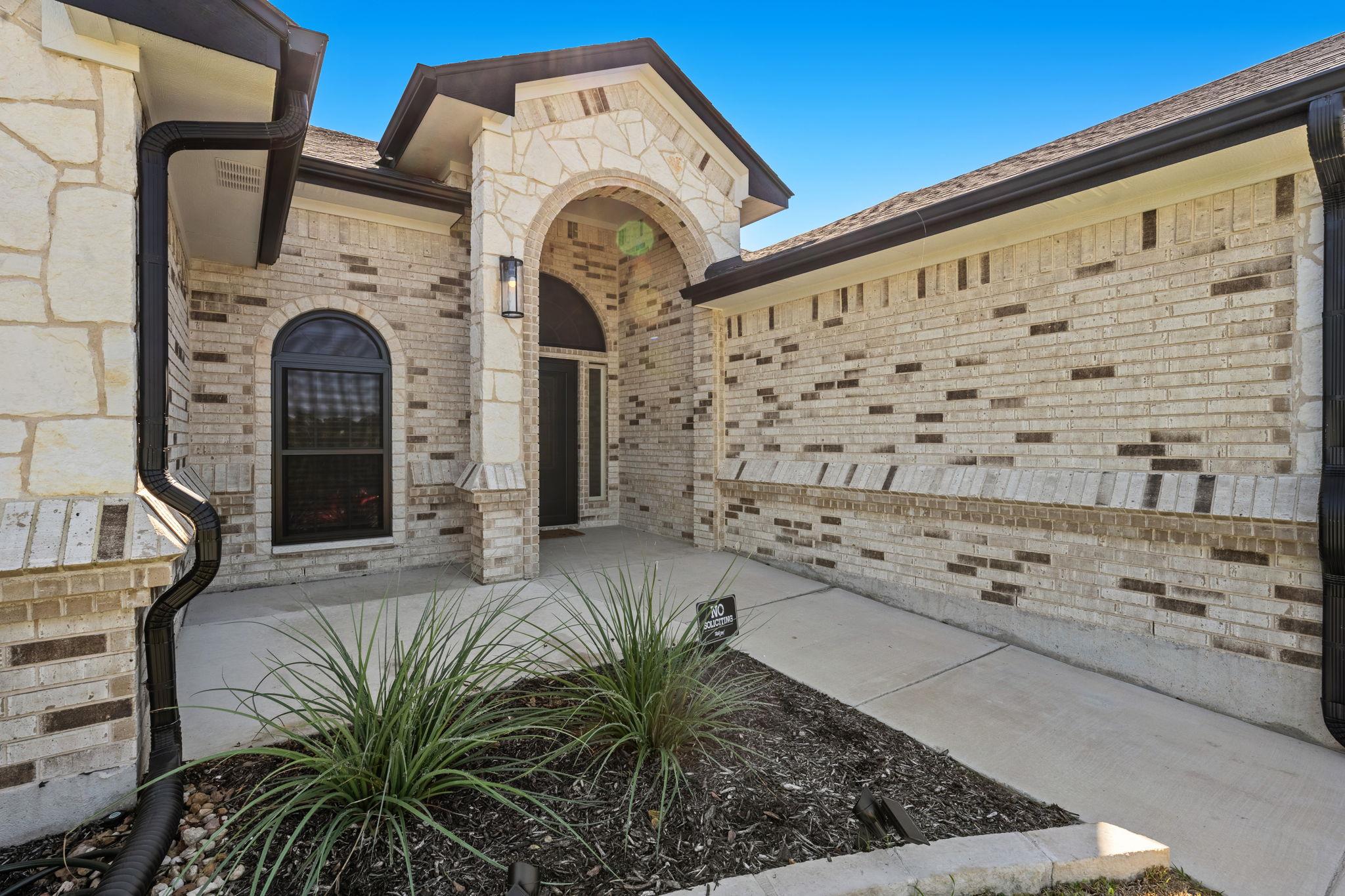 An arched stone entryway Welcomes visitors to thi