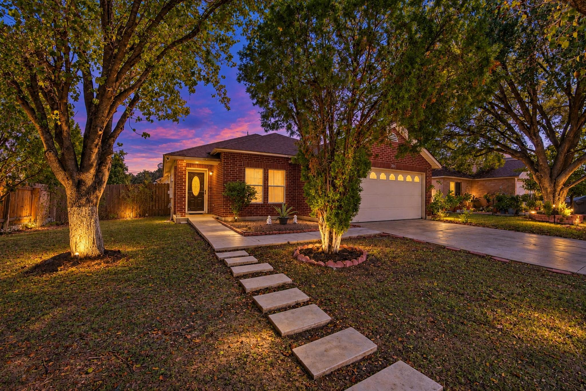 A classic brick exterior stands framed by mature 