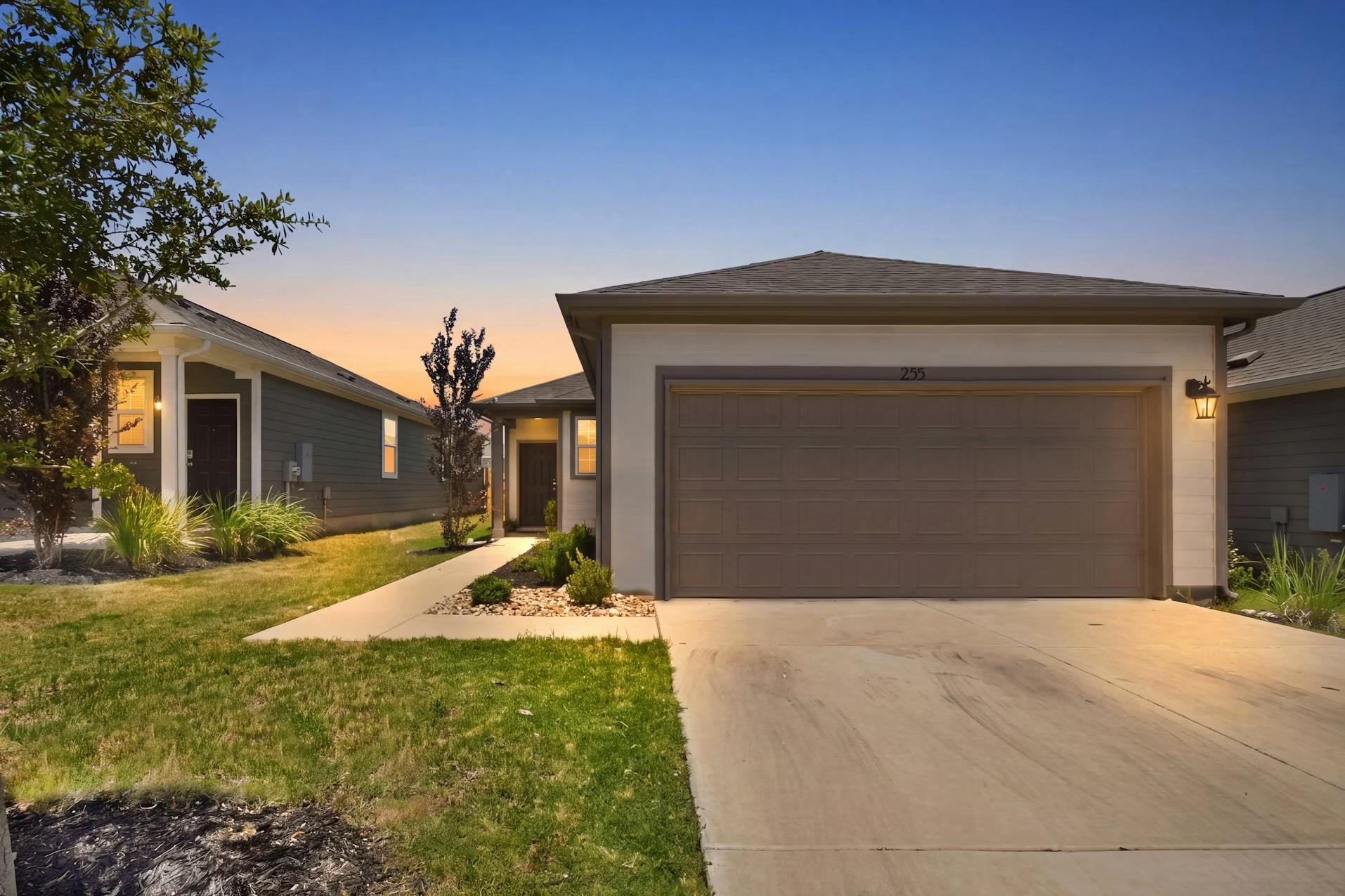 A welcoming facade presents a neatly landscaped p