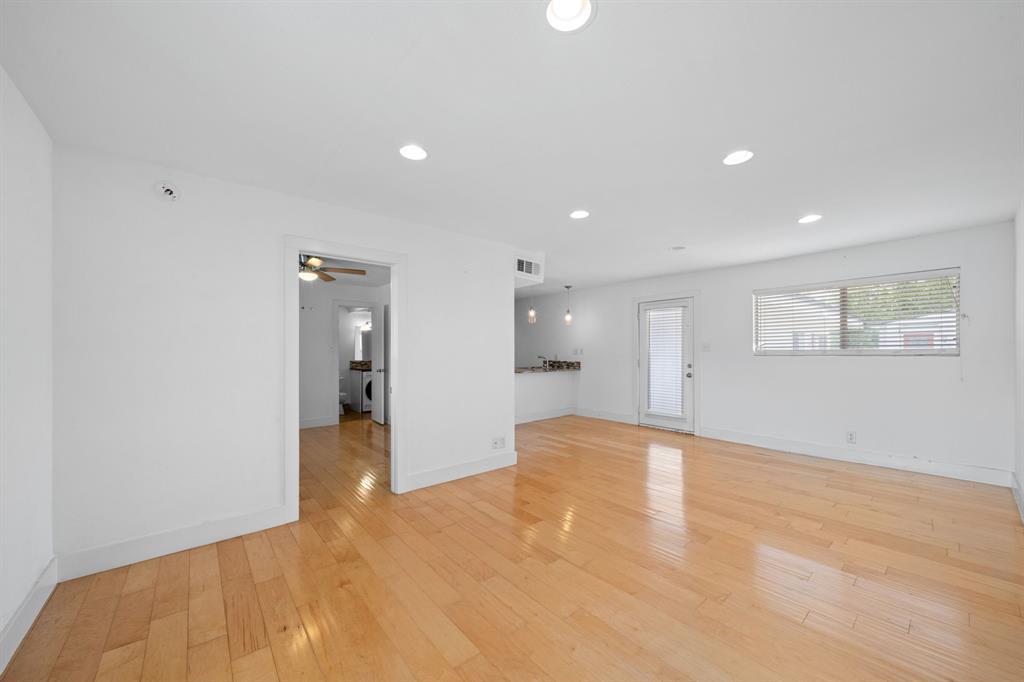 Blonde hardwood flooring stretches across an open
