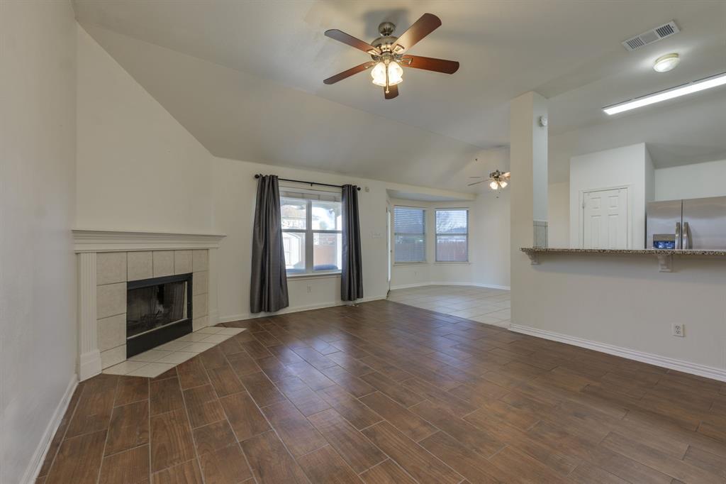 A well-lit living area showcases a corner firepla