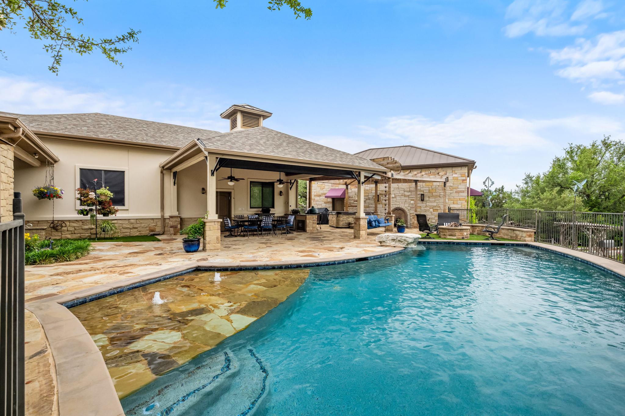 An inviting backyard oasis offers a sparkling poo