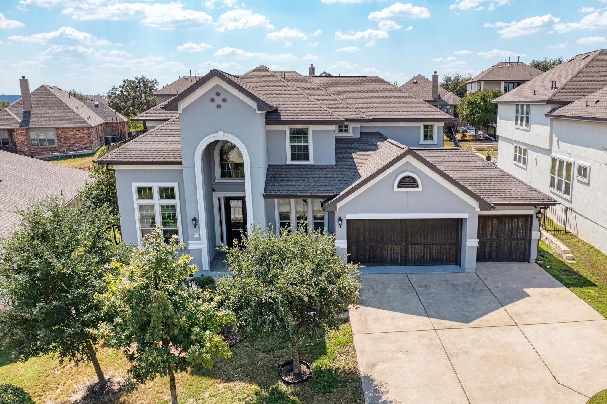 A graceful home with arched entry and multi-pane 
