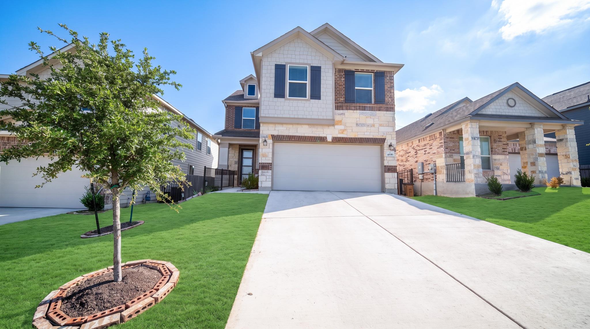 A well-maintained lawn and extended driveway welc