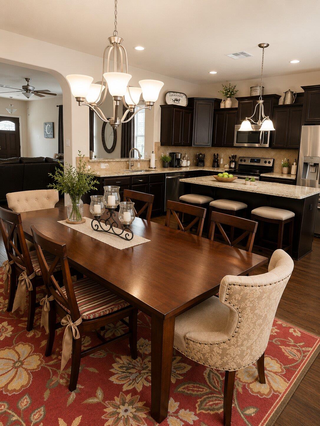 Rich wood flooring runs through this open dining 
