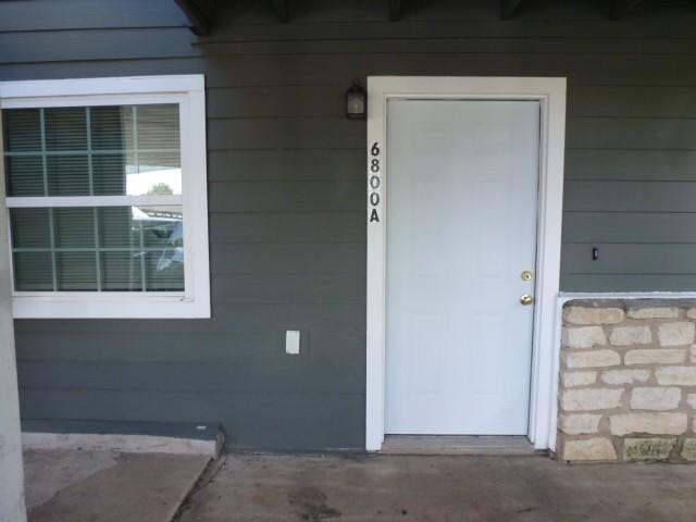 A welcoming entry features a paneled front door a