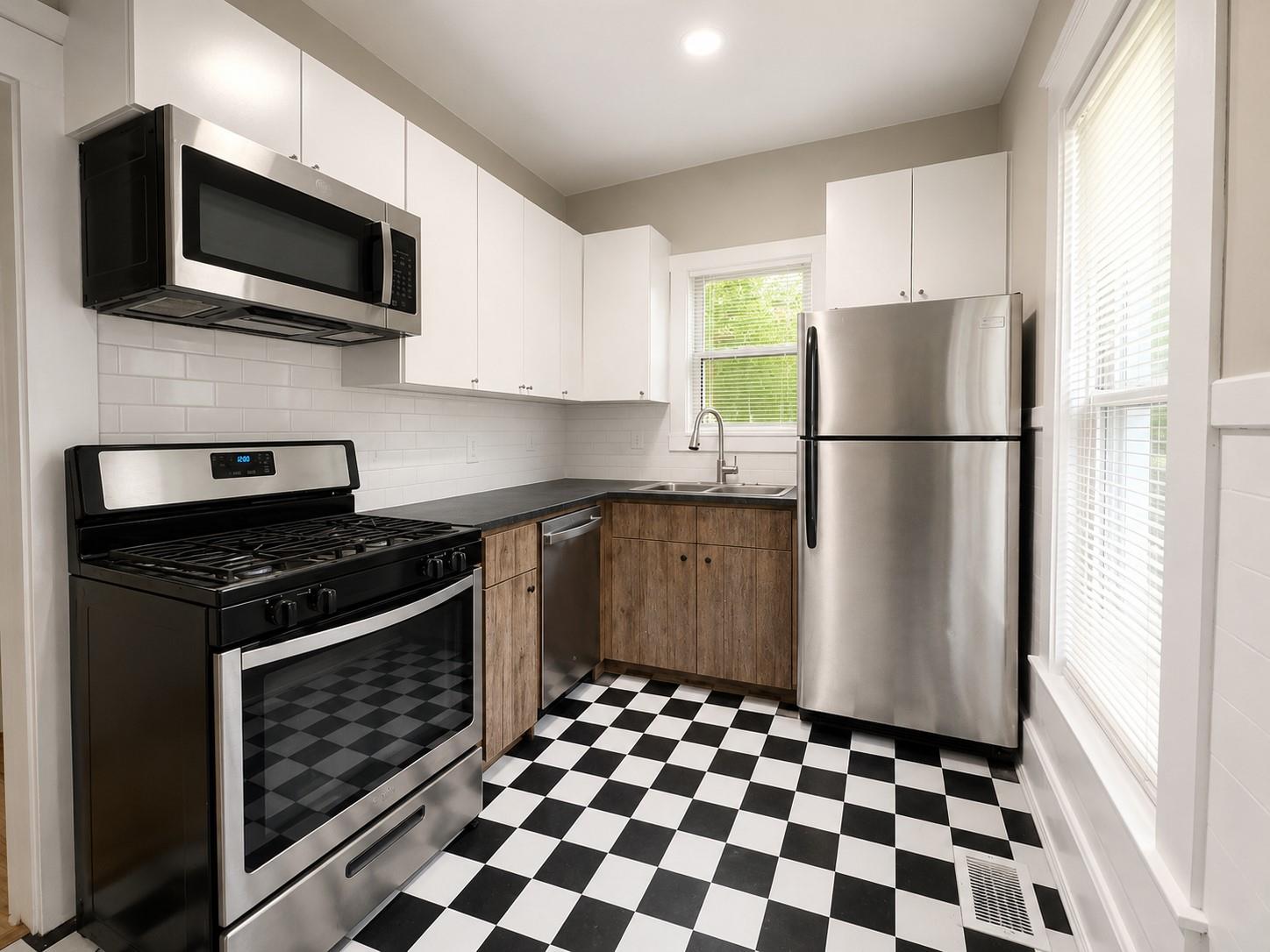 A well-equipped kitchen boasts stainless steel ap