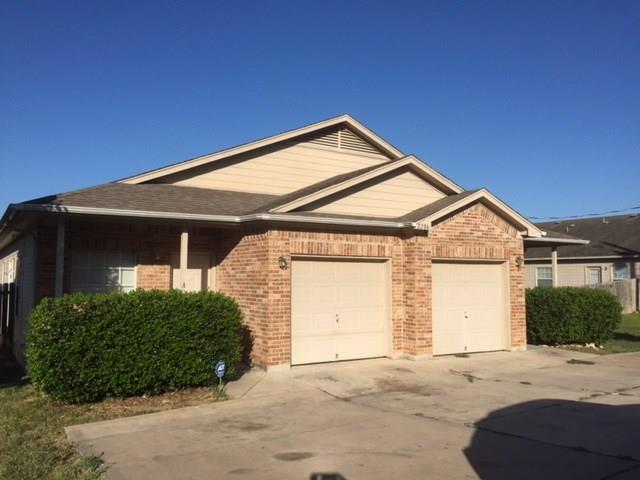 A classic brick and siding duplex with individual