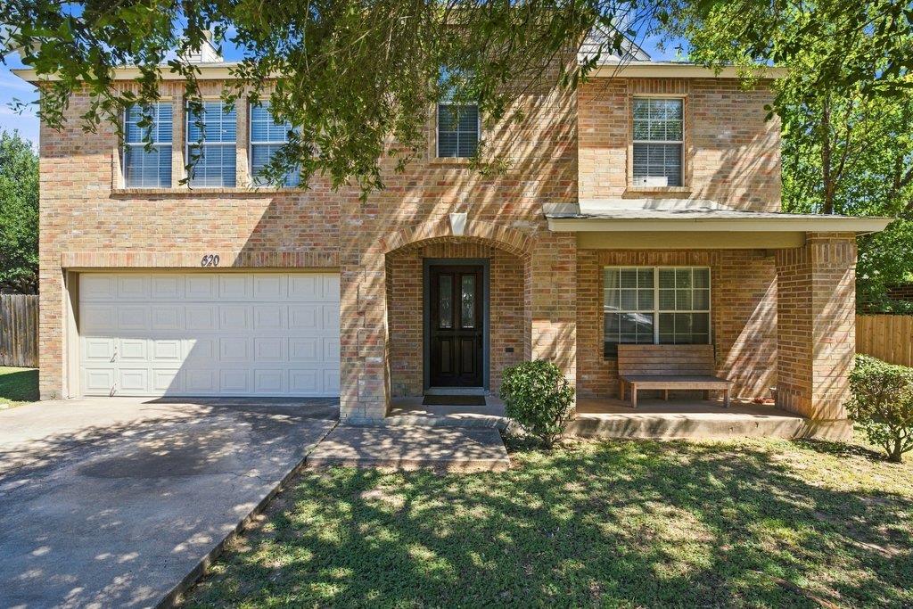 A classic brick facade and inviting covered porch