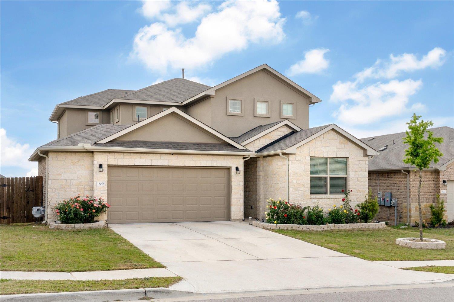 A welcoming stone facade with a neatly kept lawn 