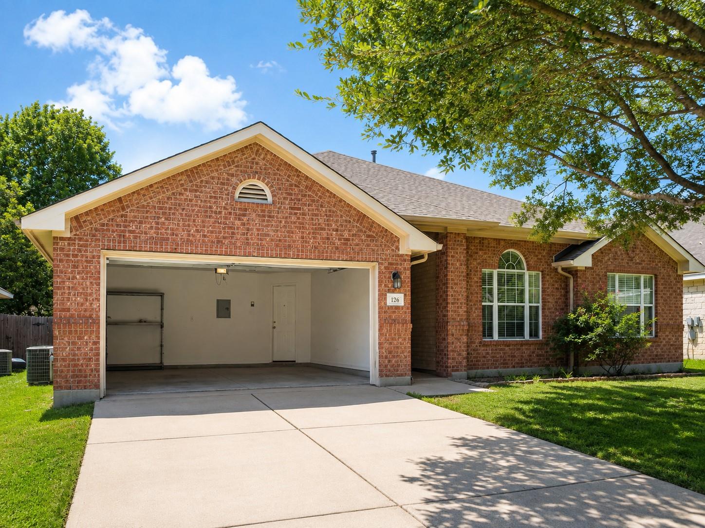 A well-maintained brick exterior with a tidy lawn